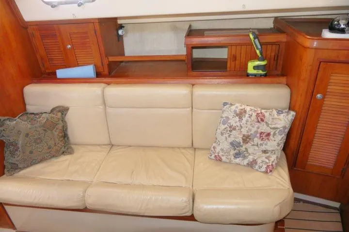 Wild Blue Yacht Photos Pics Interior of 1999 Island Packet 45 yacht with beige leather sofa and floral cushions.