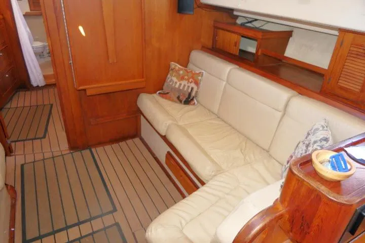 Wild Blue Yacht Photos Pics Interior of 1999 Island Packet 45 yacht with beige seating and wooden accents.