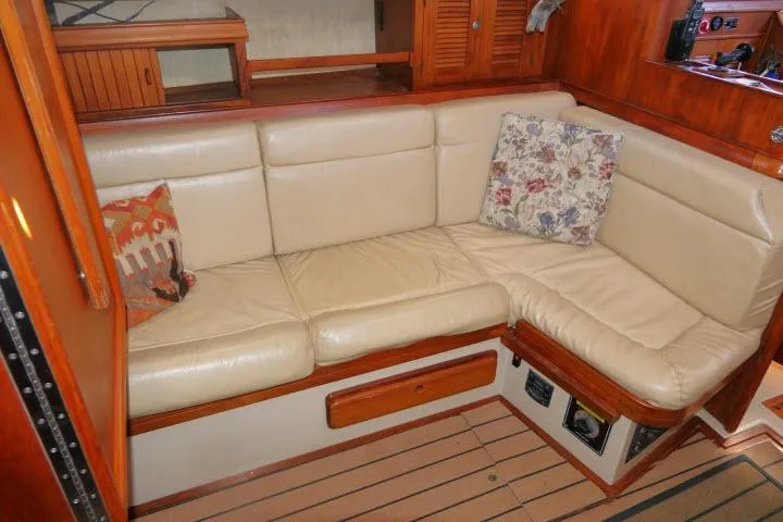 Wild Blue Yacht Photos Pics 1999 Island Packet 45 yacht interior with cream leather seating and decorative pillows.