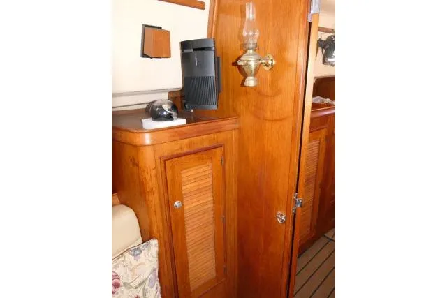 Wild Blue Yacht Photos Pics Interior of 1999 Island Packet 45 yacht with wooden cabinetry and vintage lamp.