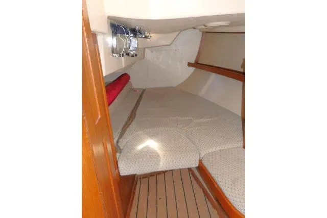 Wild Blue Yacht Photos Pics Interior cabin of 1999 Island Packet 45 sailboat with cozy bedding and wooden accents.