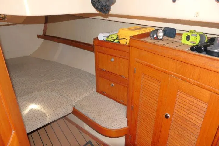 Wild Blue Yacht Photos Pics Cozy cabin interior of 1999 Island Packet 45 sailboat with wooden cabinetry and bed.