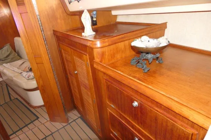 Wild Blue Yacht Photos Pics Interior of 1999 Island Packet 45 yacht with wooden cabinetry and decorative items.