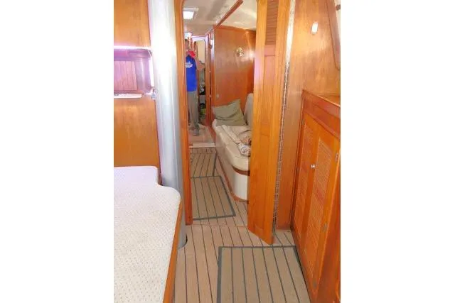 Wild Blue Yacht Photos Pics Interior of 1999 Island Packet 45 sailboat with wooden finishes and cozy seating area.