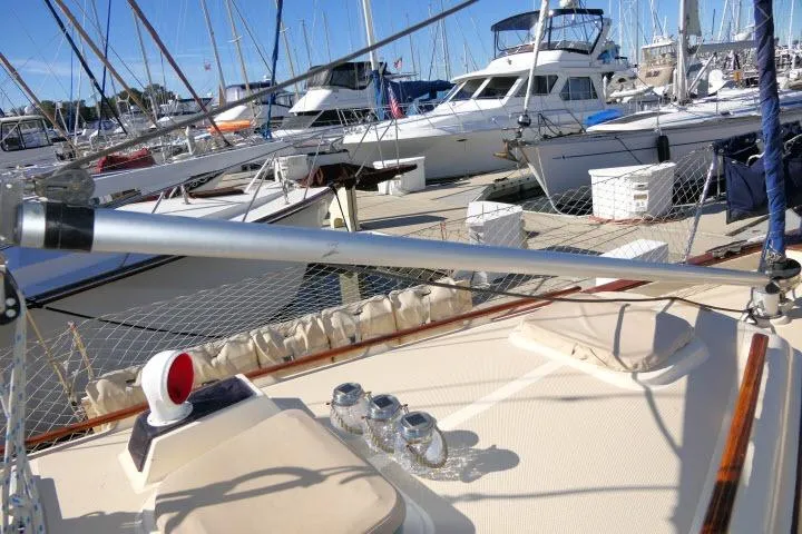 Wild Blue Yacht Photos Pics 1999 Island Packet 45 sailboat docked in a marina with other boats.