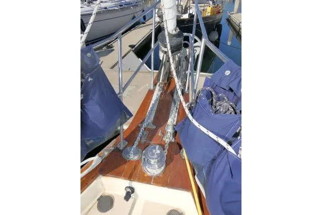 Wild Blue Yacht Photos Pics 1999 Island Packet 45 sailboat deck with blue covers and rigging at a marina.