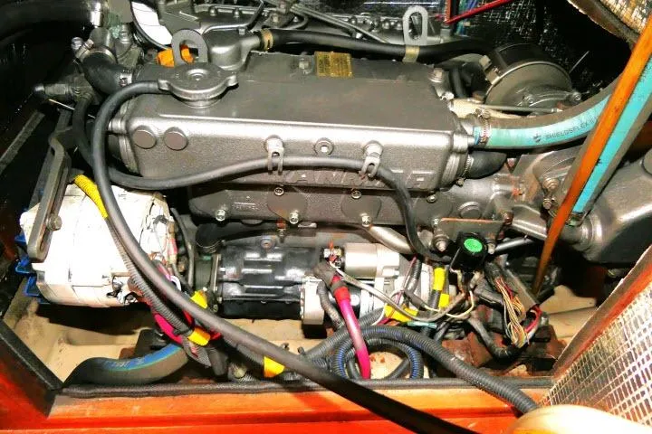 Wild Blue Yacht Photos Pics Engine compartment of a 1999 Island Packet 45 sailboat, showcasing detailed wiring and components.