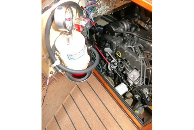 Wild Blue Yacht Photos Pics Engine compartment of 1999 Island Packet 45 sailboat, featuring mechanical components and fire extinguisher.
