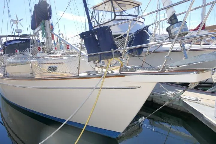 Wild Blue Yacht Photos Pics 1999 Island Packet 45 sailboat docked in marina, featuring sleek design and sturdy build.