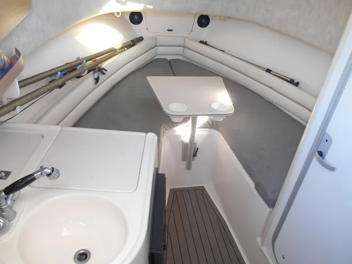Strike Zone Yacht Photos Pics 2002 Grady-White 282 Sailfish cabin interior with seating, table, and sink.