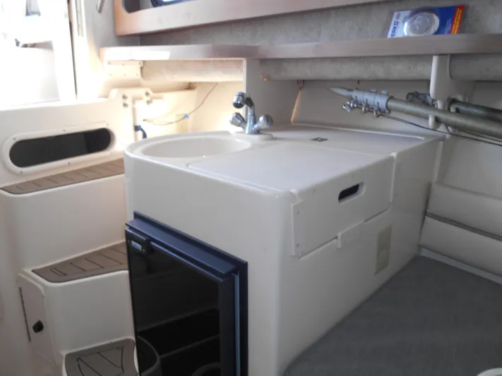 Strike Zone Yacht Photos Pics 2002 Grady-White 282 Sailfish interior with compact kitchenette and storage.