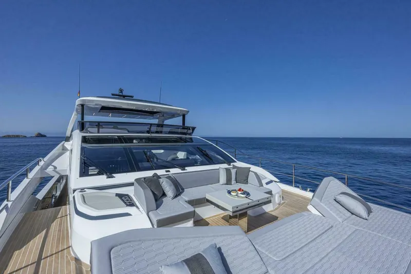 82 Pearl Yacht Photos Pics Luxurious 2026 Pearl 82 yacht with elegant deck seating, cruising on a calm ocean.