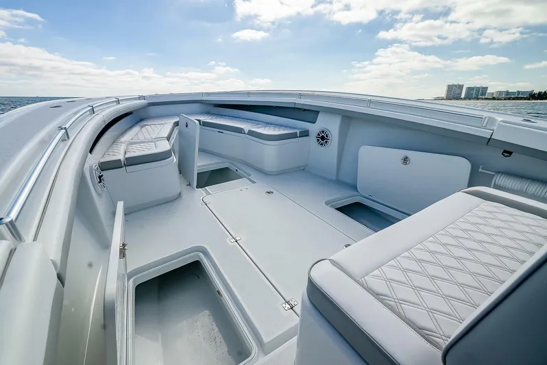  Yacht Photos Pics 2023 Yellowfin 36 Offshore boat interior with cushioned seating and storage compartments.