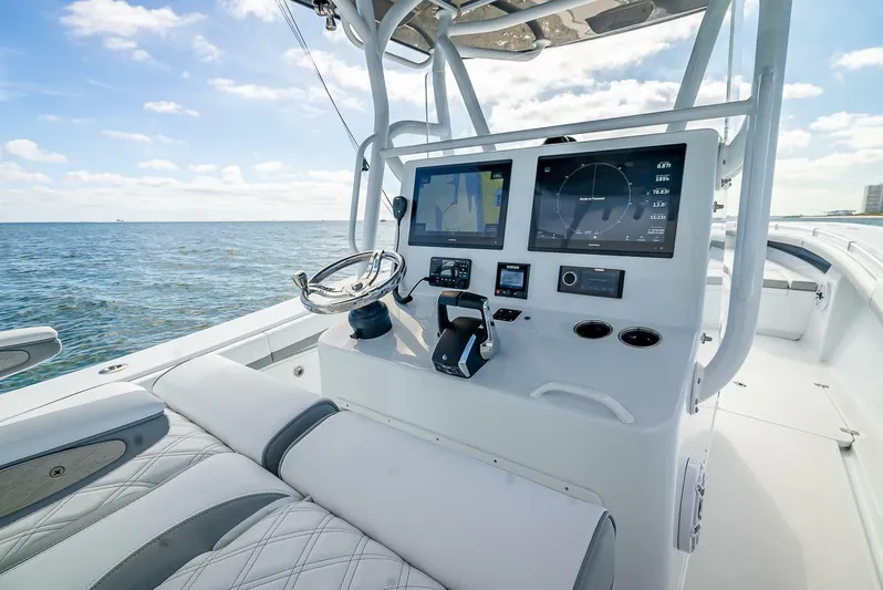  Yacht Photos Pics 2023 Yellowfin 36 Offshore boat dashboard with modern navigation equipment on open water.