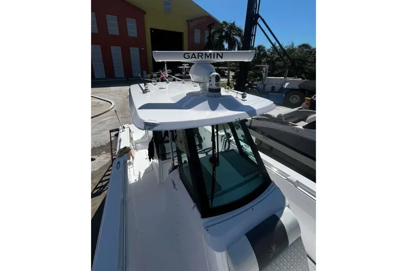  Yacht Photos Pics 2024 Bertram 28 CC boat with Garmin radar, docked in a marina.