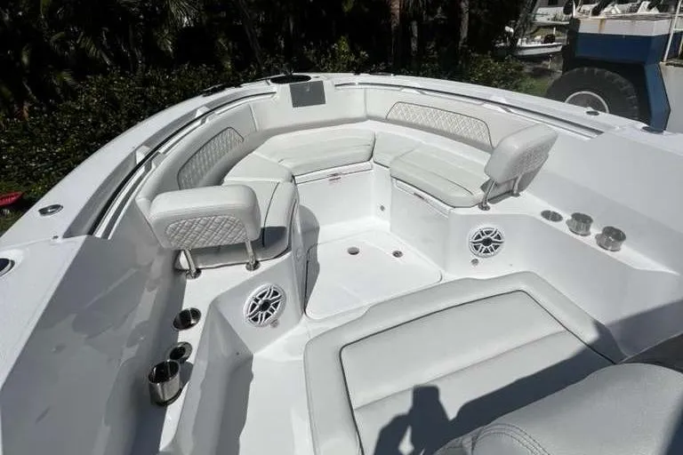  Yacht Photos Pics 2024 Bertram 28 CC boat interior with white seating and cup holders.