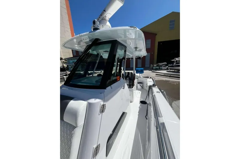  Yacht Photos Pics 2024 Bertram 28 CC boat with sleek design and modern features, docked outdoors.