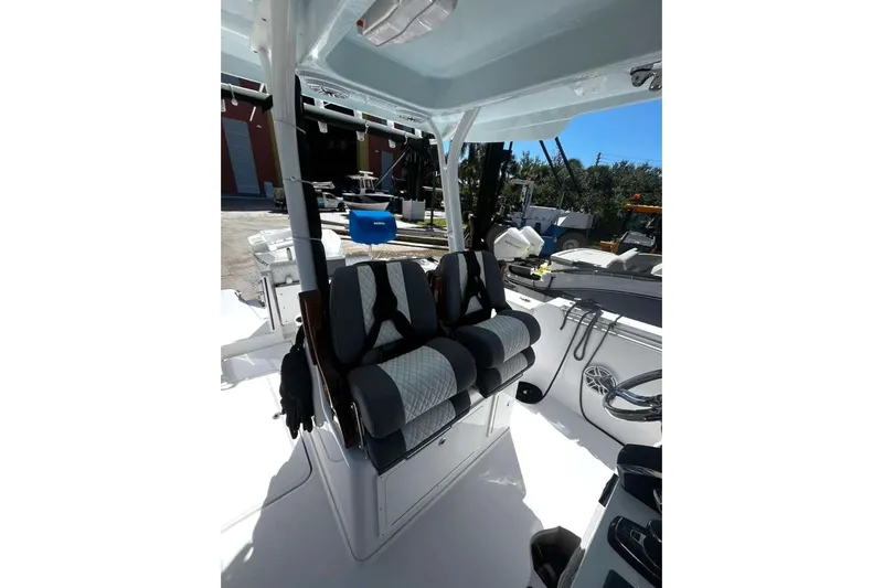  Yacht Photos Pics 2024 Bertram 28 CC boat interior with cushioned seating and modern design.