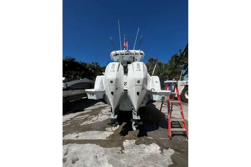  Yacht Photos Pics 2024 Bertram 28 CC boat with dual outboard engines, parked on a sunny day.