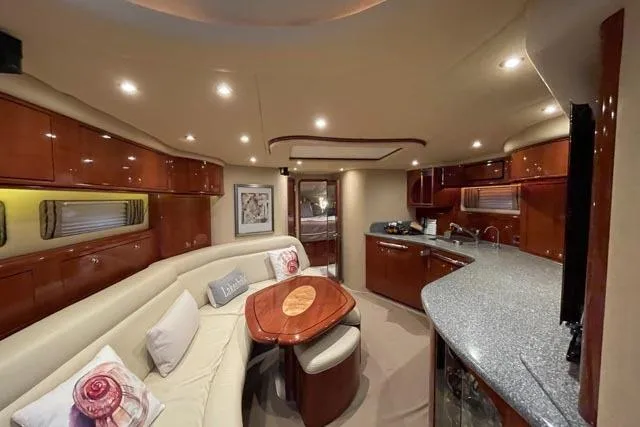 Tigress Yacht Photos Pics Luxurious interior of 2002 Sea Ray 550 Sundancer yacht with elegant seating and modern kitchen.