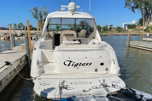 Tigress Yacht Photos Pics 2002 Sea Ray 550 Sundancer yacht docked, rear view with "Tigress" name visible.