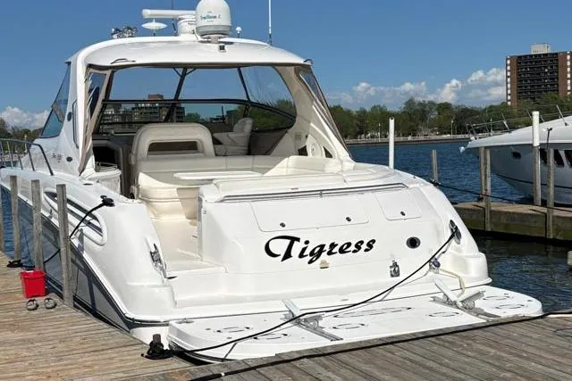 Tigress Yacht Photos Pics 2002 Sea Ray 550 Sundancer yacht docked, named "Tigress," with clear skies and waterfront view.