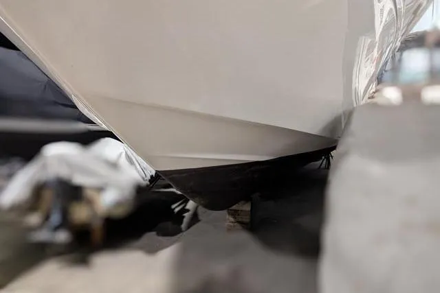 Tigress Yacht Photos Pics 2002 Sea Ray 550 Sundancer boat hull in dry dock, close-up view.