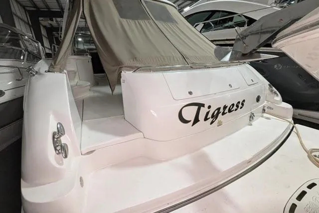 Tigress Yacht Photos Pics 2002 Sea Ray 550 Sundancer yacht, named "Tigress," docked in a marina.