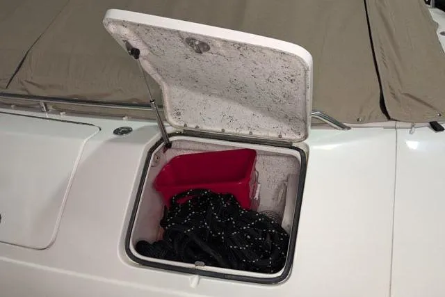 Tigress Yacht Photos Pics Open storage compartment on 2002 Sea Ray 550 Sundancer boat with red container and ropes.