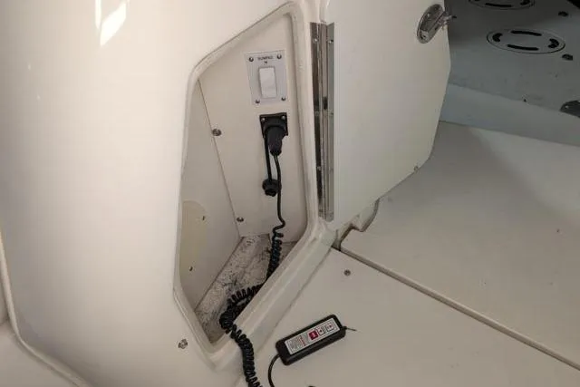 Tigress Yacht Photos Pics 2002 Sea Ray 550 Sundancer interior compartment with control panel and coiled cable.