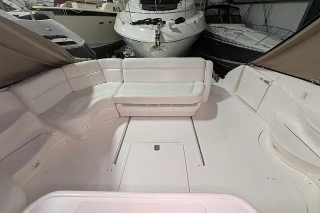 Tigress Yacht Photos Pics 2002 Sea Ray 550 Sundancer yacht interior with white seating in a marina.