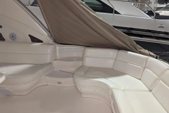 Tigress Yacht Photos Pics 2002 Sea Ray 550 Sundancer yacht interior with white leather seating and canopy.