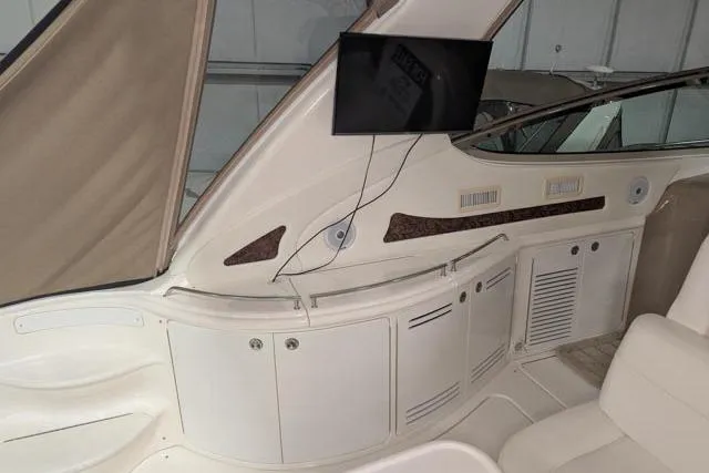Tigress Yacht Photos Pics 2002 Sea Ray 550 Sundancer interior with TV and storage cabinets.