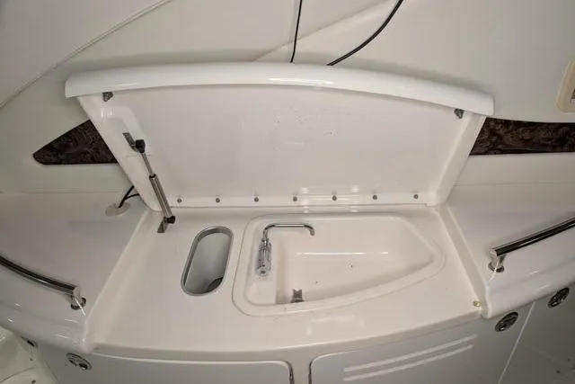 Tigress Yacht Photos Pics 2002 Sea Ray 550 Sundancer yacht sink area with open lid and faucet.