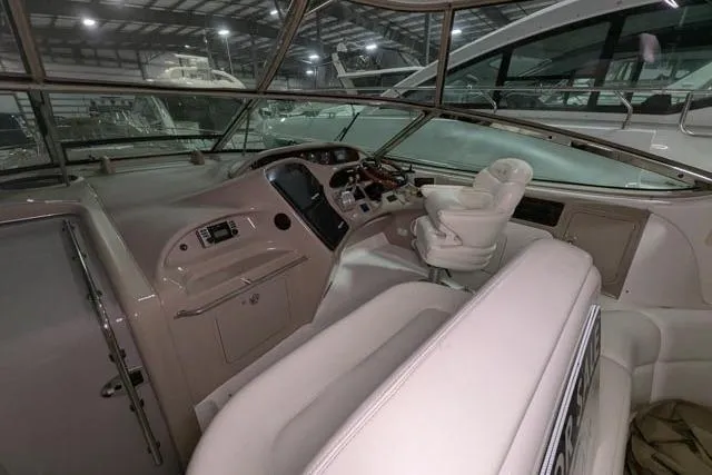 Tigress Yacht Photos Pics Interior view of 2002 Sea Ray 550 Sundancer yacht cockpit with helm and seating.