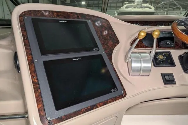 Tigress Yacht Photos Pics Control panel of a 2002 Sea Ray 550 Sundancer yacht with dual screens and throttle controls.