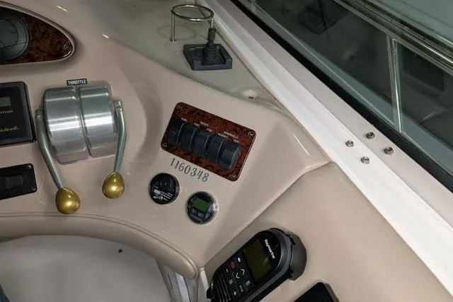 Tigress Yacht Photos Pics Control panel of a 2002 Sea Ray 550 Sundancer boat with throttle and gauges.