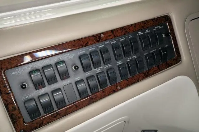 Tigress Yacht Photos Pics Control panel of a 2002 Sea Ray 550 Sundancer yacht with multiple switches.