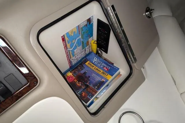 Tigress Yacht Photos Pics Compartment in 2002 Sea Ray 550 Sundancer with maps and waterway guide.