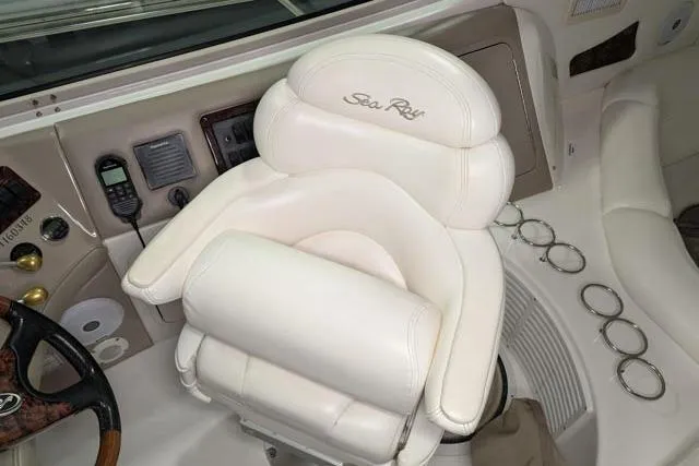 Tigress Yacht Photos Pics Captain's chair on 2002 Sea Ray 550 Sundancer yacht, featuring plush white upholstery.