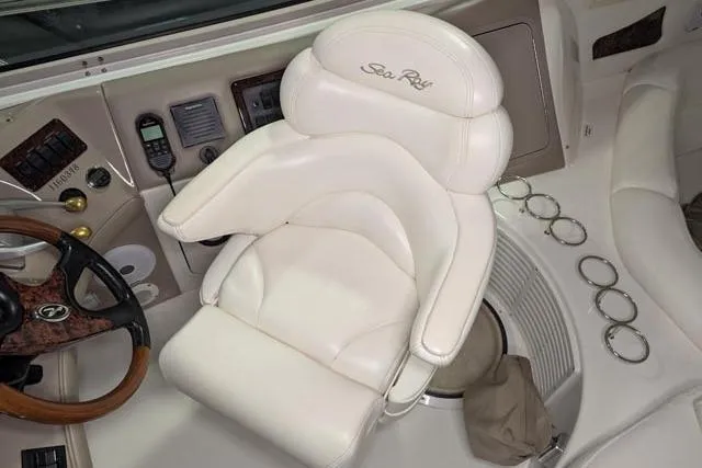 Tigress Yacht Photos Pics Captain's chair on 2002 Sea Ray 550 Sundancer yacht, featuring luxurious white leather upholstery.
