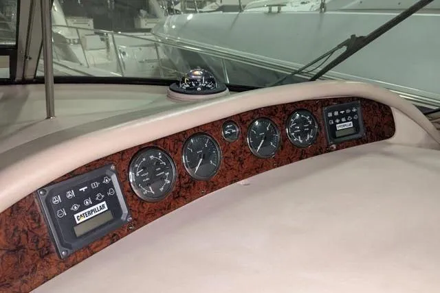 Tigress Yacht Photos Pics Control panel of a 2002 Sea Ray 550 Sundancer yacht with gauges and navigation instruments.