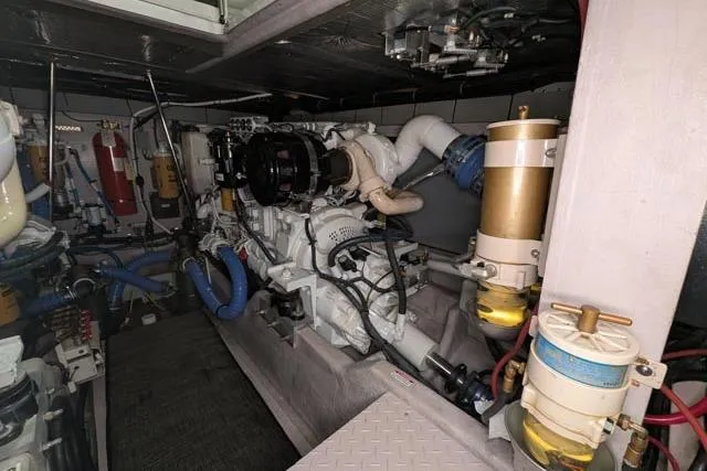 Tigress Yacht Photos Pics Engine room of a 2002 Sea Ray 550 Sundancer yacht, showcasing mechanical components.