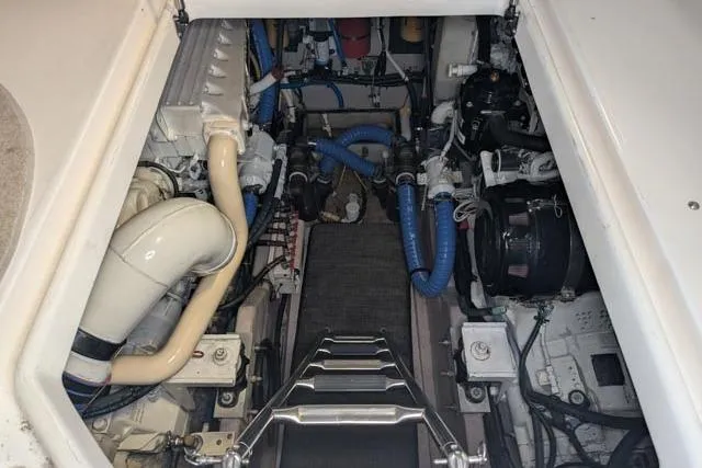 Tigress Yacht Photos Pics Engine room of a 2002 Sea Ray 550 Sundancer with visible components and piping.