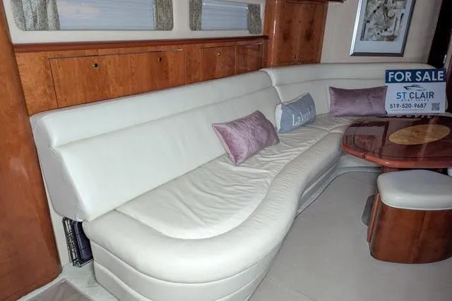 Tigress Yacht Photos Pics Luxurious interior of 2002 Sea Ray 550 Sundancer yacht with plush seating and wooden accents.