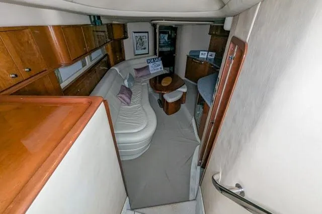 Tigress Yacht Photos Pics 2002 Sea Ray 550 Sundancer interior with elegant seating and wooden cabinetry.