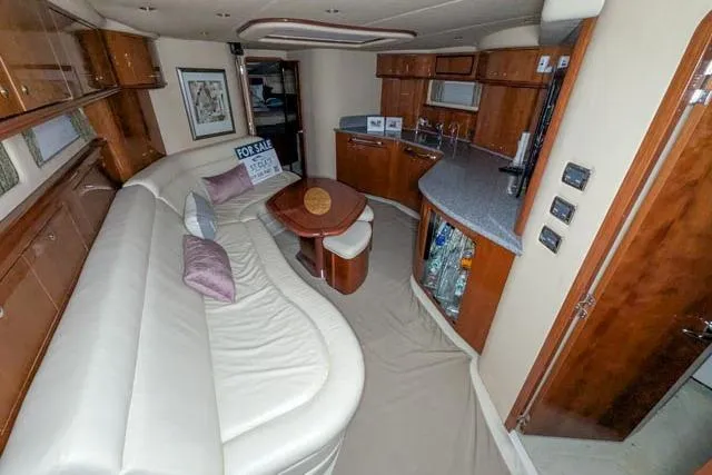 Tigress Yacht Photos Pics Luxurious interior of 2002 Sea Ray 550 Sundancer yacht with elegant seating and kitchen area.