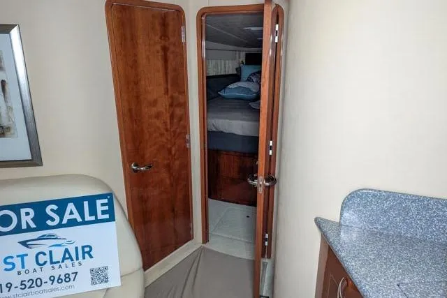 Tigress Yacht Photos Pics 2002 Sea Ray 550 Sundancer interior with wooden doors and countertop, for sale by St. Clair Boat Sales.