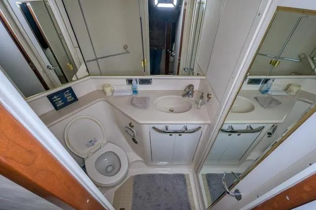 Tigress Yacht Photos Pics Bathroom interior of 2002 Sea Ray 550 Sundancer yacht, featuring sink and toilet.