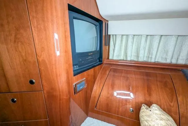 Tigress Yacht Photos Pics Interior of 2002 Sea Ray 550 Sundancer with wood cabinetry and built-in TV.